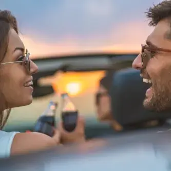 Couple in car with cocacola